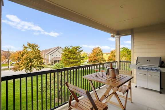 a patio with a table and chairs and a grill at Stonepost Ranch, Overland Park, KS, 66221