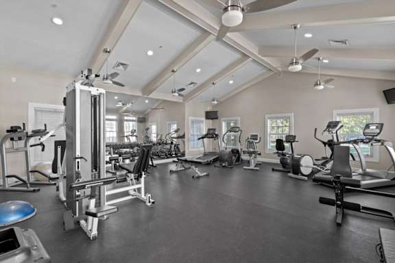 a gym with various exercise equipment and windows