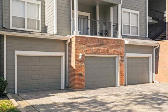 three garage doors on the side of a house