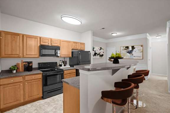 a kitchen with a bar and black appliances at Stonepost Ranch, Kansas