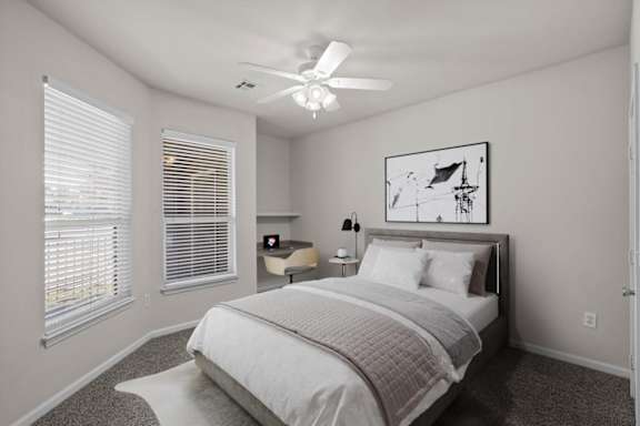 a bedroom with a bed and a ceiling fan