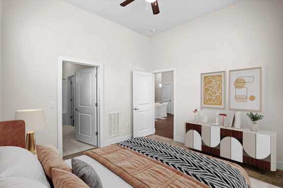 a bedroom with a bed and a door to a bathroom at West 39th Street Apartments, Kansas City, 64111