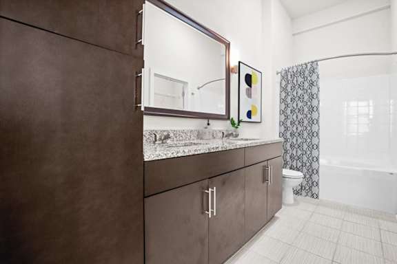 a bathroom with a sink and a mirror at West 39th Street Apartments, Kansas City, 64111