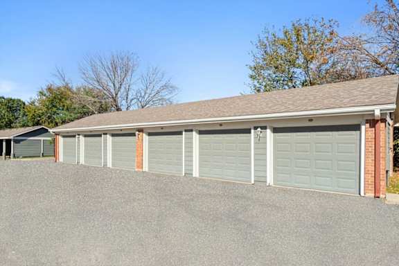 a row of garage doors in front of a house