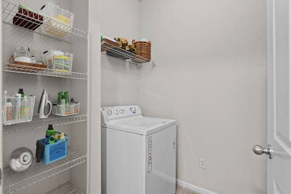 a white washer and dryer in a room with a closet