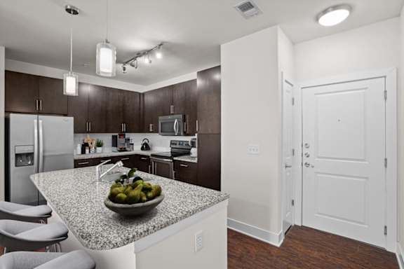 a kitchen with a counter top with a bowl of fruit at West 39th Street Apartments, Kansas City, 64111