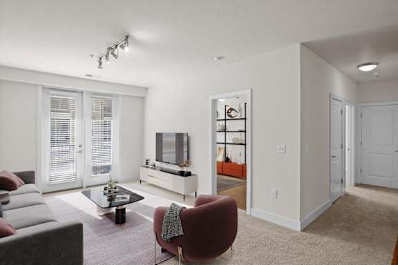 a living room with a couch and a tv at West 39th Street Apartments, Kansas City, 64111