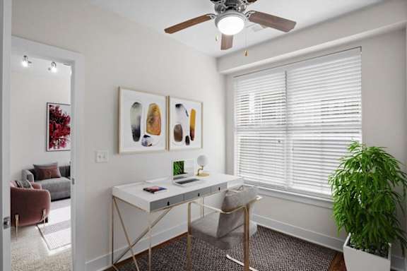 a home office with a large window and a ceiling fan at West 39th Street Apartments, Kansas City, 64111