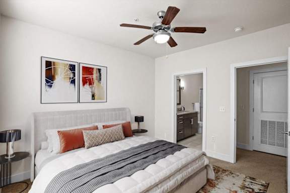 a bedroom with a bed and a ceiling fan at West 39th Street Apartments, Kansas City, 64111