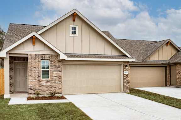 A house with a brown garage door and a grey door.