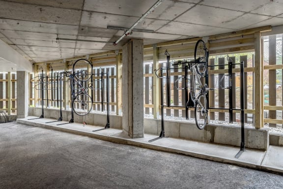 the inside of a building with bikes hanging on the wall
