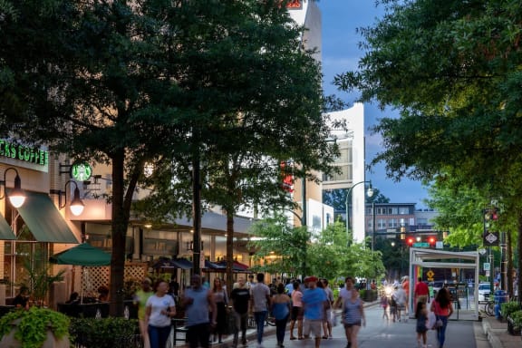 a city street filled with people and trees