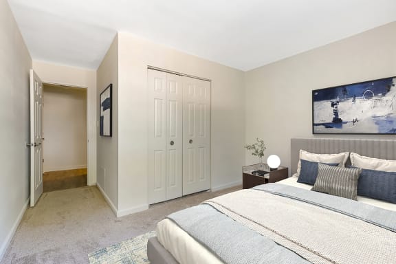 a bedroom with a large bed and two closets at Copper and Quarry Village, Pikesville, MD, 21209