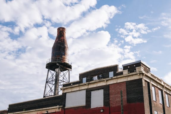 a rusty water tower on top of a brick building