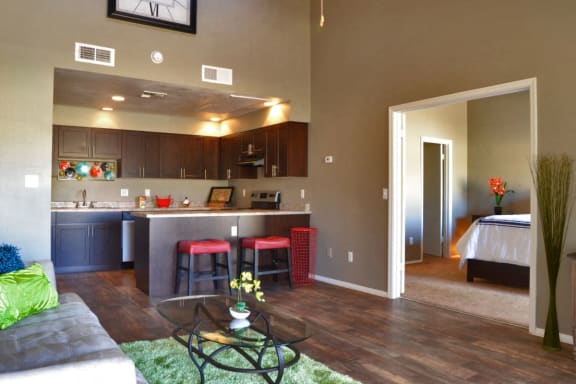 a living room and kitchen with a table and chairs