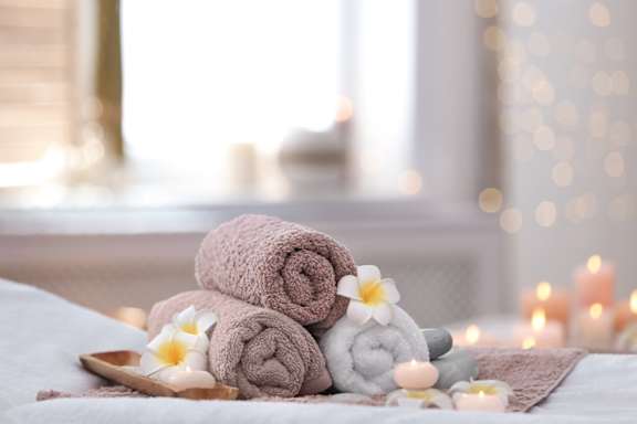 Rolled Towels and Candles on Table