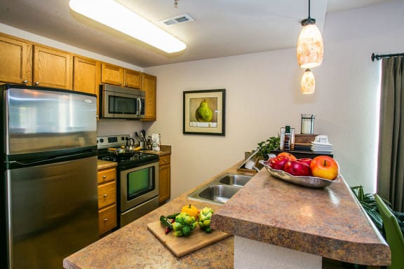 Full kitchen with granite countertops at Albuquerque apartments near golf course