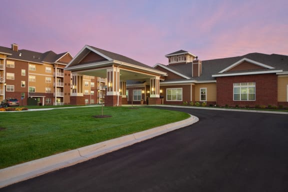 Exterior at twilight at Skye at Arbor Lakes Apartments, Maple Grove, Minnesota
