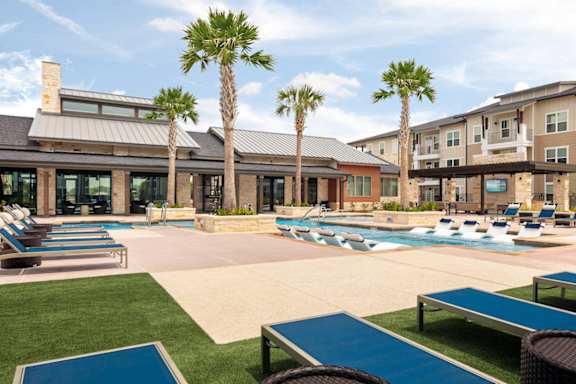 Inviting outdoor amenity area with a sparkling pool, resort-inspired landscaping, and plenty of room to enjoy the sunshine.