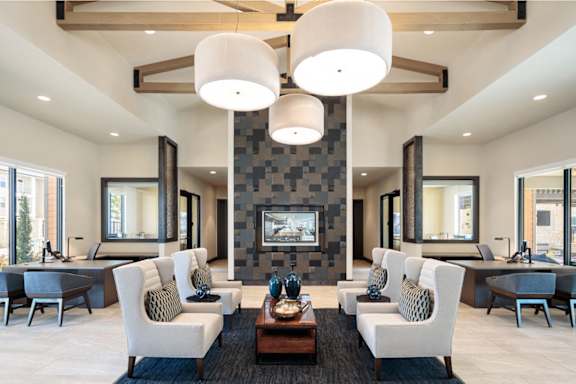 Luxurious resident lounge featuring soaring ceilings, designer lighting, and comfortable seating areas for gathering and relaxation.