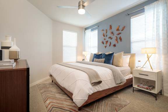 Spacious bedroom featuring large windows, plush carpeting, and contemporary finishes for a comfortable retreat.