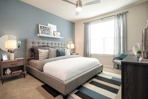 Spacious bedroom featuring large windows, plush carpeting, and contemporary finishes for a comfortable retreat.