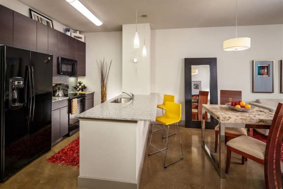 Open Concept Kitchen with Island/ Breakfast Bar at Apartments for Rent Oak Lawn Dallas
