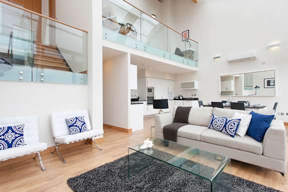 a living room with a couch and a glass table