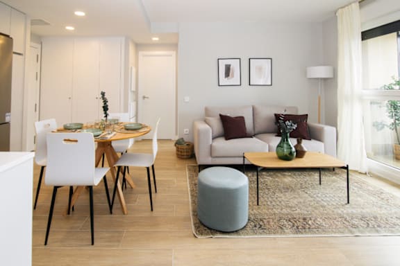 a living room and dining room with a table and chairs