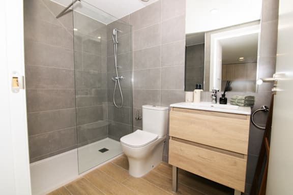 a bathroom with a toilet and a shower