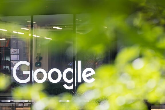 a logo is pictured on the glass facade of a google offices in london