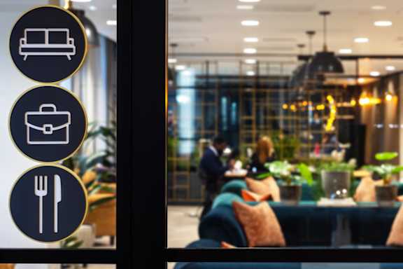 a window view of a restaurant with people sitting at a table