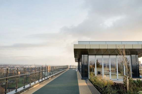 a building with glass walls and a balcony overlooking a city at Vox Apartments, Manchester, M15 4YD