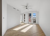 Thumbnail 49 of 51 - A room with a ceiling fan and a door leading outside at Brickside Heights, Utah, 84106