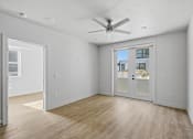 Thumbnail 47 of 51 - A room with a ceiling fan and a view of a building outside the window at Brickside Heights, Millcreek, 84106
