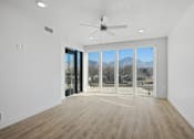 Thumbnail 29 of 51 - A room with a ceiling fan and sliding glass doors at Brickside Heights, Millcreek, 84106