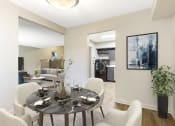 Thumbnail 6 of 13 - a dining area with a table and chairs and a living room in the background at Copper and Quarry Village, Pikesville, MD, 21209