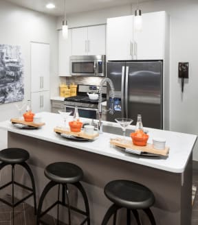 a kitchen with stainless steel appliances and white cabinets