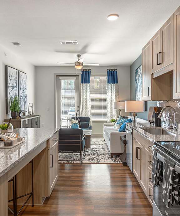 A modern kitchen with granite countertops and stainless steel appliances.