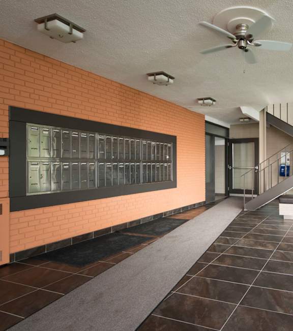 A long hallway with a bench and a fan.