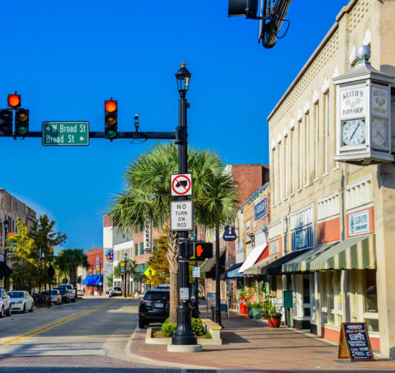 a city street with cars parked on the side of the road