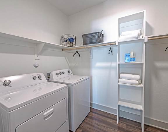 A white laundry room with a washer and dryer.