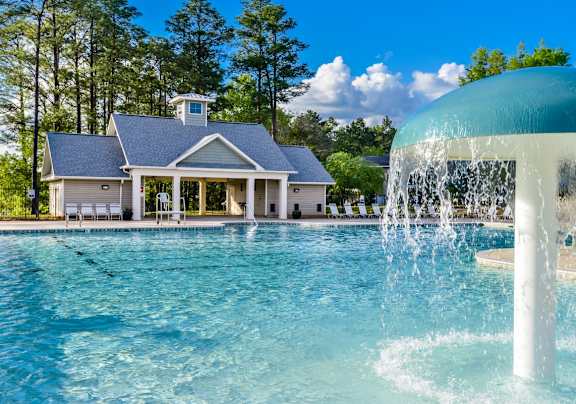 A house with a pool and a waterfall.
