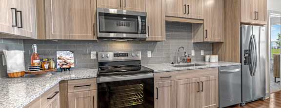 A kitchen with wooden cabinets and stainless steel appliances.