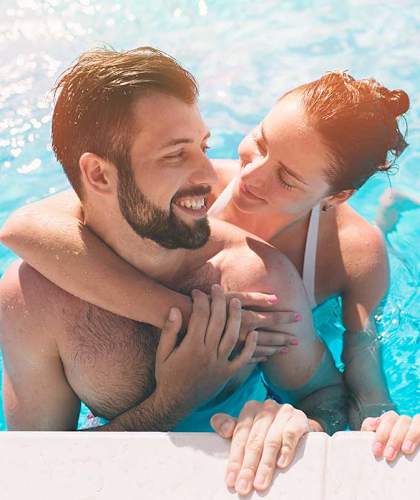 a couple hugging in a swimming pool