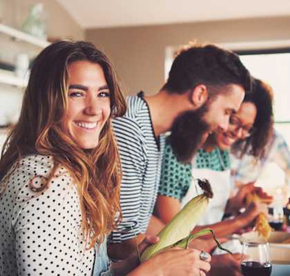 a group of people in a kitchen preparing food