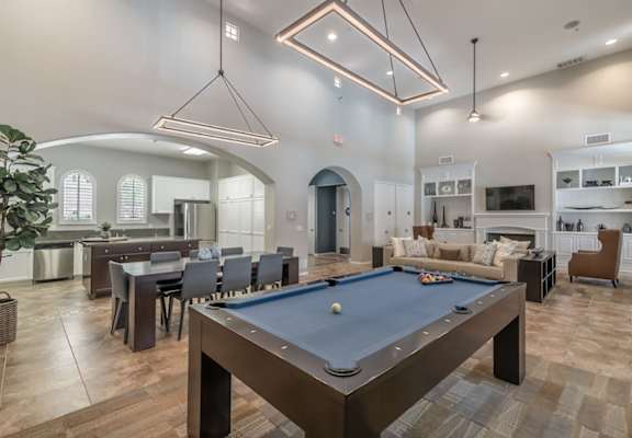 an open floor plan with a pool table in the center of the room