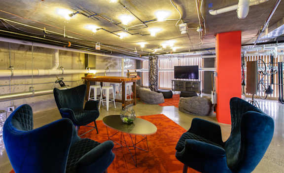 A room with blue chairs and a red carpet.