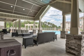 A patio with a pool and furniture.