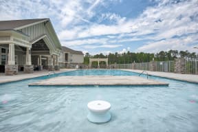 A swimming pool with a toilet floating in it.
